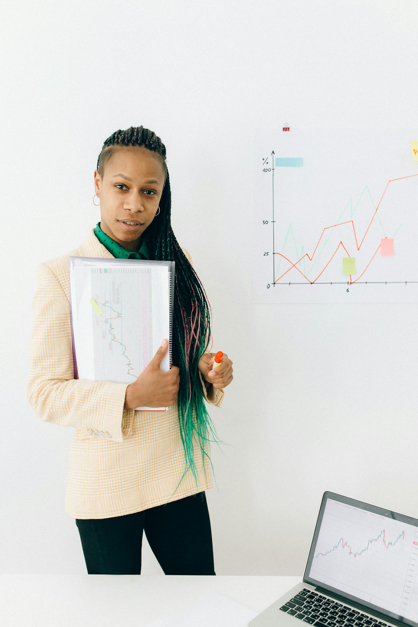 confident analyst presenting financial data and growth charts in a modern office setting. 7172979 1365x2048