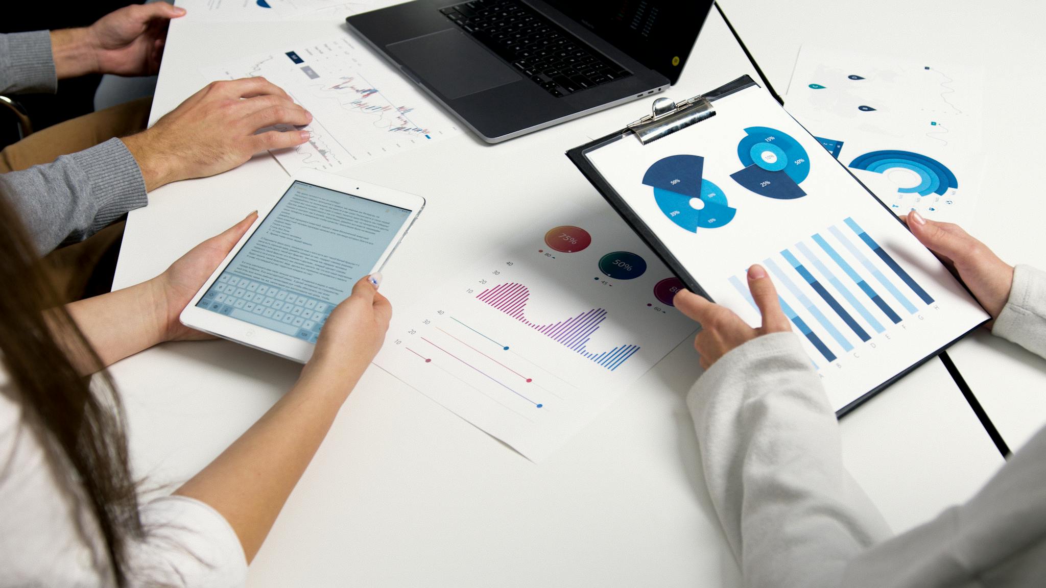 team analyzing financial charts and digital reports